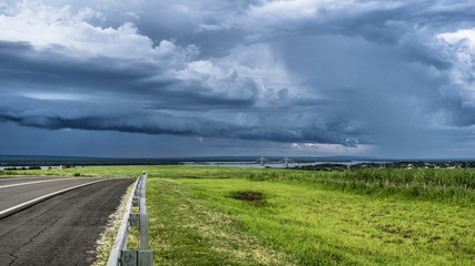  Border divided by a river, with a background bridge and a rainy sky