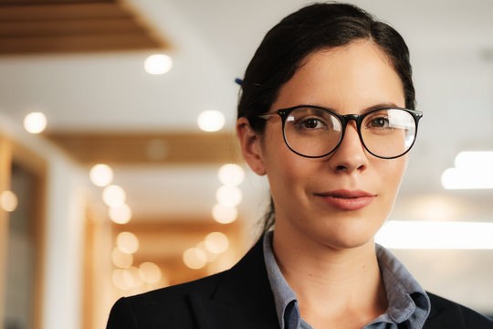 Portrait Closeup of Smiling Businesswoman in Office With Copyspace