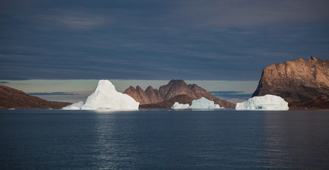 arctic landscape with icebergs among east Greenland fjords