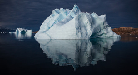 arctic landscape with icebergs among east Greenland fjords