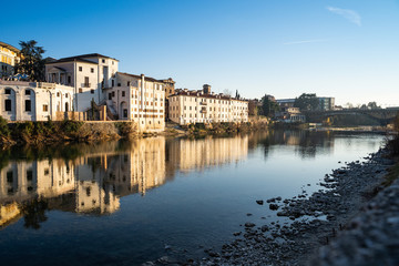 Fototapeta na wymiar View of Bassano del Grappa, in Italy, from the river beside the castle