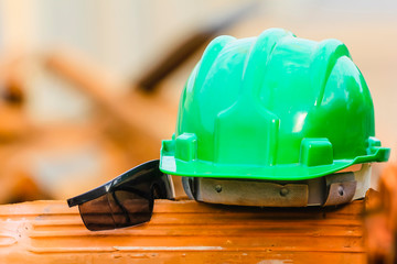 Green helmet and goggles under construction in Brazil. Concept of safety, individual protection...