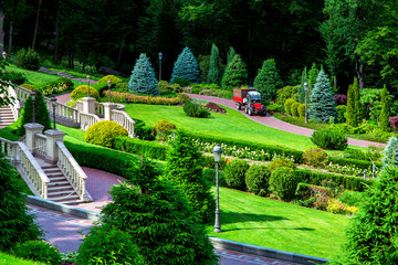 Park for walking with stairs and balusters with a variety of green plantings in the form of trees...