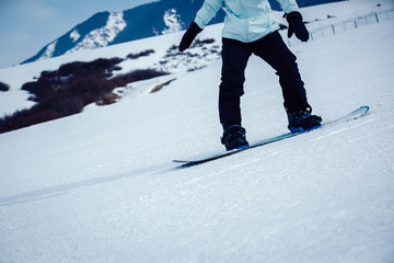 one snowboarder snowboarding in winter mountains