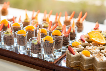 Chocolate moose topping​ with​ fresh​ fruit​ and butter cake in line buffet
