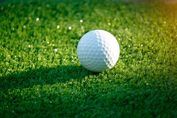 Golf ball on green in beautiful golf course at bokeh background. Golf equipment on green in golf course
