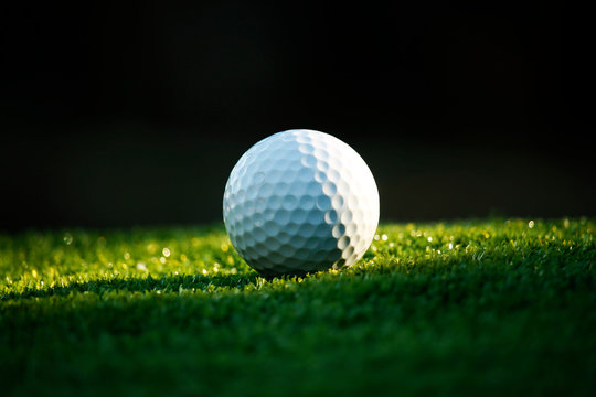 Golf ball on green in beautiful golf course at bokeh background. Golf equipment on green in golf course