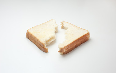 bread torned  in half on white background.