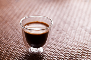 Cup of espresso coffee on wooden background.