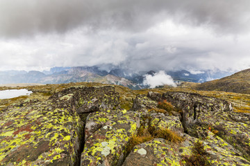 Fototapeta na wymiar Beautiful scenery in the Dolomite Alps, with rain clouds, mist, and limestone peaks