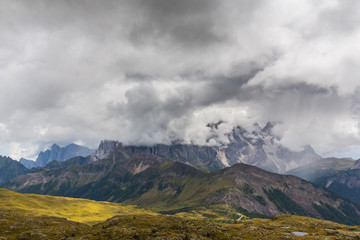 Beautiful scenery in the Dolomite Alps, with rain clouds, mist, and limestone peaks