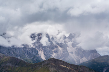 Obraz na płótnie Canvas Beautiful scenery in the Dolomite Alps, with rain clouds, mist, and limestone peaks