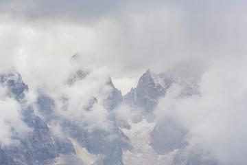 Beautiful scenery in the Dolomite Alps, with rain clouds, mist, and limestone peaks