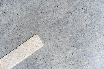 Outdoor road with 45-degree rotated white marking line on the left side texture. Perfect for background.
