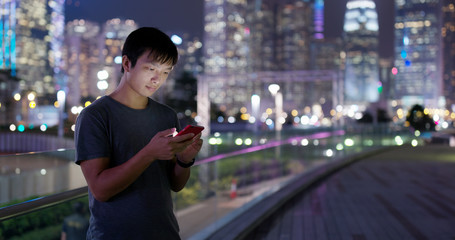 Man use of mobile phone over buisness building background