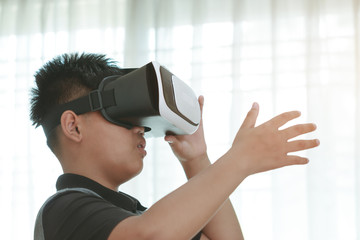 Asian student wearing vr / virtual reality headset over technology digital virtual screen background for learning study new simulation sci and game, Futuristic innovation device concept