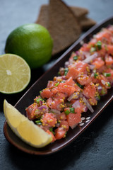 Close-up of salmon tartare, vertical shot, selective focus