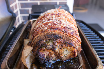 Roasted Pork with crackling skin in an oven roasting tin