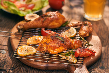 Hot and spicy chicken drumstick and wings closeup with beer