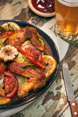 Grilled chicken wings spiced with chili peppers and rosemary