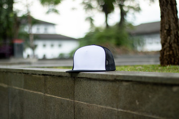 Trucker hat cap flat visor with black and white color in outdoor, ready for your mock up design