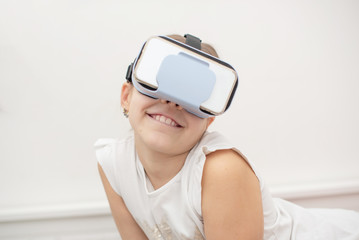 child with virtual reality glasses. emotional portrait of child experiencing 3D gadget. selective focus. 