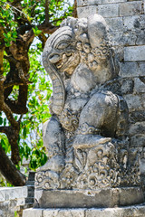 Fototapeta na wymiar Very old elephant shape stone sculpture covered with moss and lichens in Bali