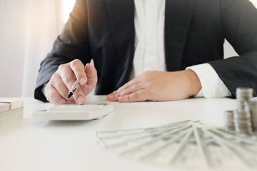 businessman using the calculator about investment plan  funds and banking concept