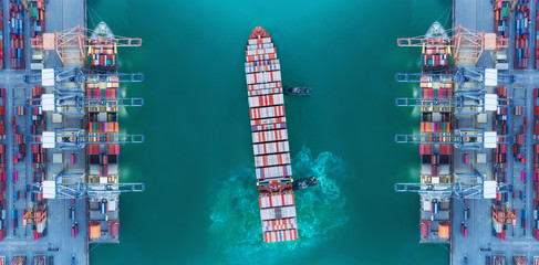 Aerial top view panoramic Tug boat and Container ship moving pass sea port warehouse and crane ship working for delivery containers shipment, logistics import import or transportation concept.