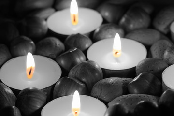 Hazelnuts, walnuts and pecan nuts with tea light candles with selective colour