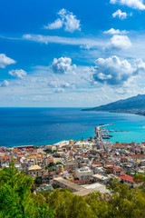 Greece, Zakynthos, Turquoise ocean water behind harbor and cityscape of zakynthos town from above