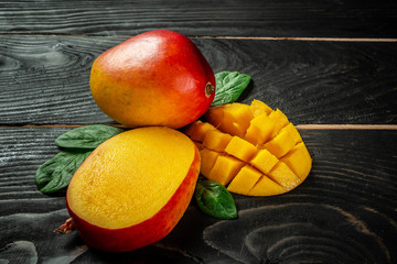 Close-up tropical fruit Mango on a dark wooden background. Flat lay. place for text. Food concept