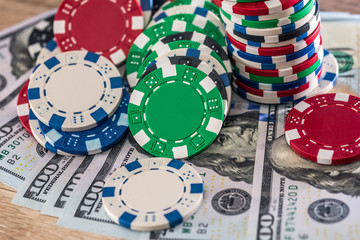 Dollar banknotes on wooden table with casino chips