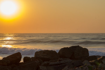 sunrise over the indian ocean with rock in foreground 