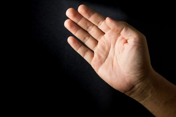 Hand on black background,