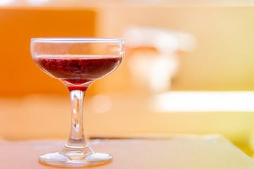 Red wine glass on background.