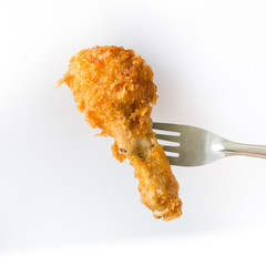 Fried chicken leg with silverware on white background