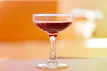 Red wine glass on background.