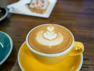 Coffee late art in cup on table
