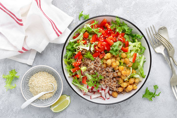 Healthy and delicious bowl with buckwheat and salad of chickpea, fresh pepper and lettuce leaves. Dietary balanced plant-based food. Vegan and vegetarian dish. Top view. Flat lay