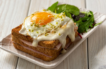 Croque madame, hot french toasts with ham , cheese and egg. 