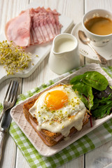 Croque madame, hot french toasts with ham , cheese and egg. 