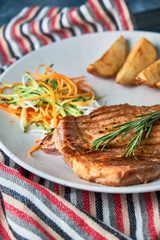 grilled beef steak with vegetables on plate