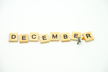 Miniature people Construction worker standing with wood word Month. using as background business concept and calendar concept with copy space  for your text