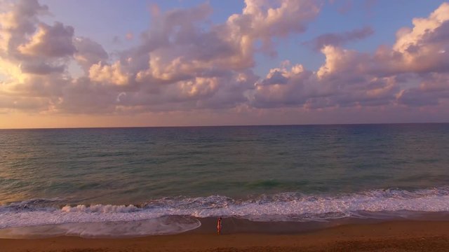 Young Happy Couple Walk Along Calm Sea Beach