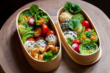 Colorful vegan bento lunch box with green vegetables and tofu
