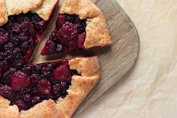 Homemade berry cake on wooden cutting board
