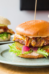 Juicy american hamburger with cheese, grilled ground meat, toppings