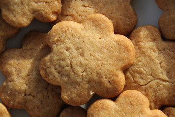 Flower shape biscuit. Golden biscuit over a white background.