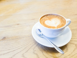 Hot Coffee Latte with a heart shape in cream foam for Valentines Day and copy space. (Love concept)